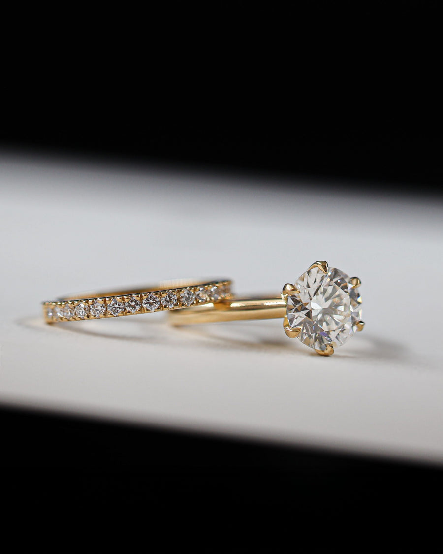 round diamiond yellow gold engagement ring with matching diamond wedding band