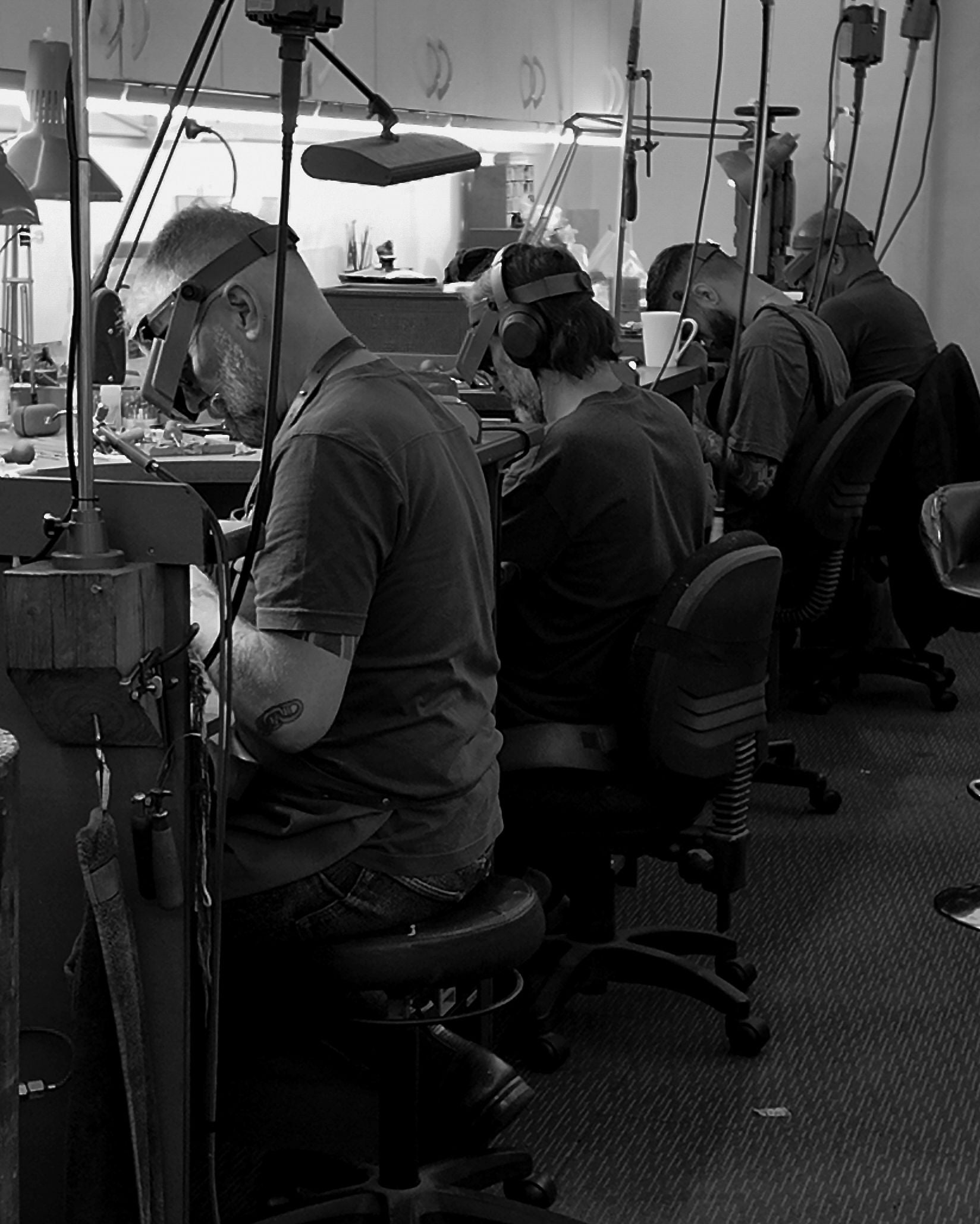 jewellers sitting at their workshop bench 