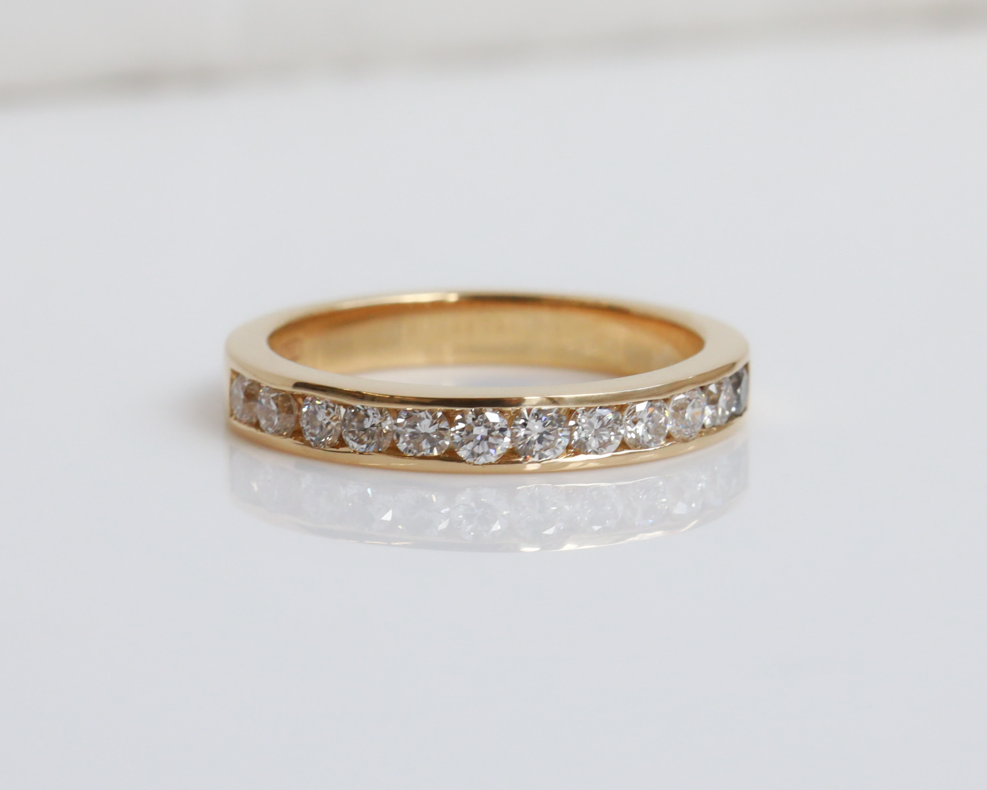 Gold ring with diamonds on a white background