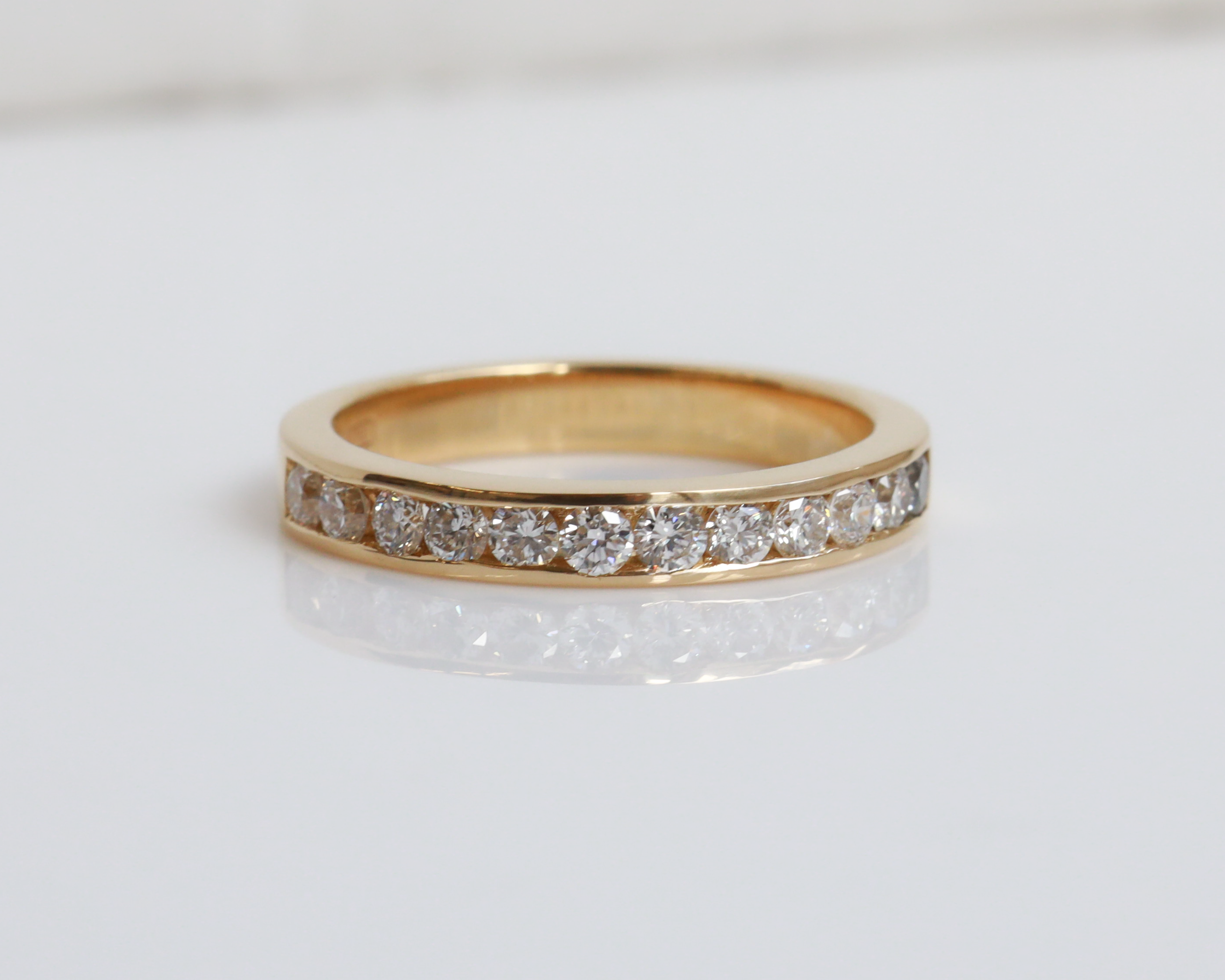 Gold ring with diamonds on a white background