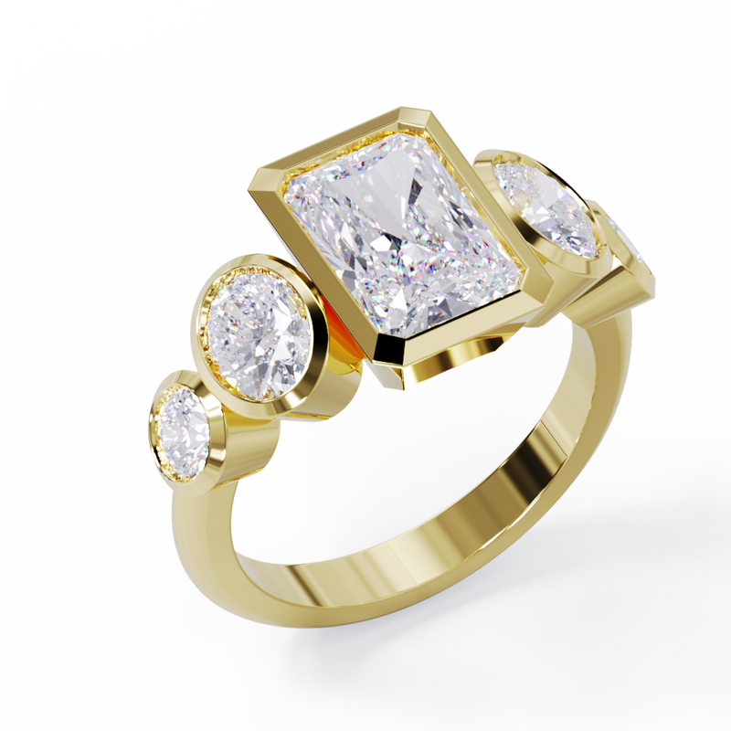 Yellow Gold ring with a central emerald-cut diamond flanked by two oval diamonds. Bezel set in a low profile. Angled view