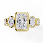 Yellow Gold ring with a central emerald-cut diamond flanked by two oval diamonds. Bezel set in a low profile. Top view