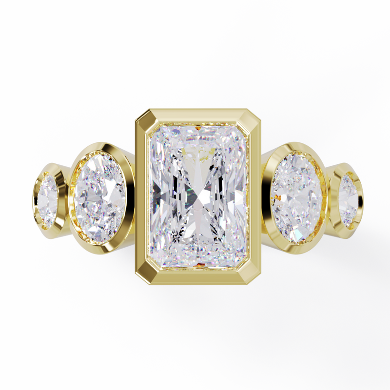 Yellow Gold ring with a central emerald-cut diamond flanked by two oval diamonds. Bezel set in a low profile. Top view