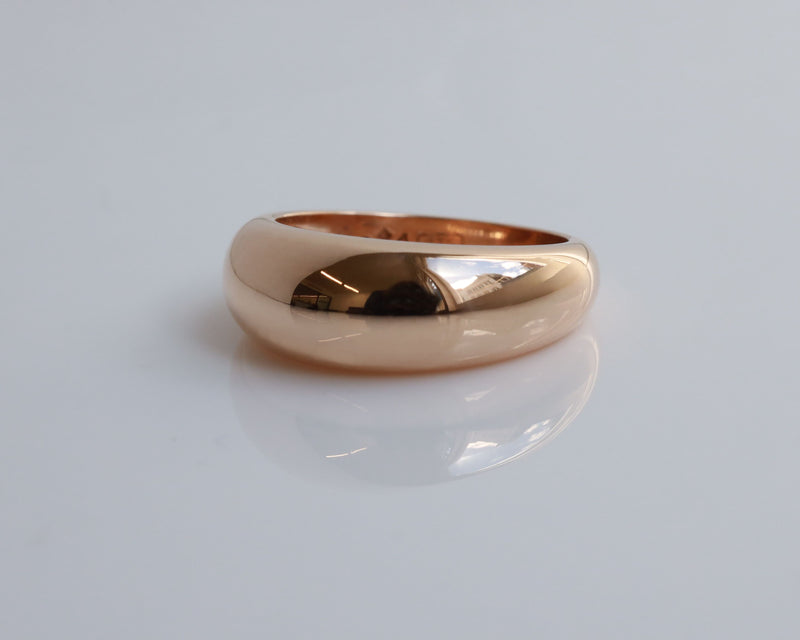 Rose gold ring on a light gray background