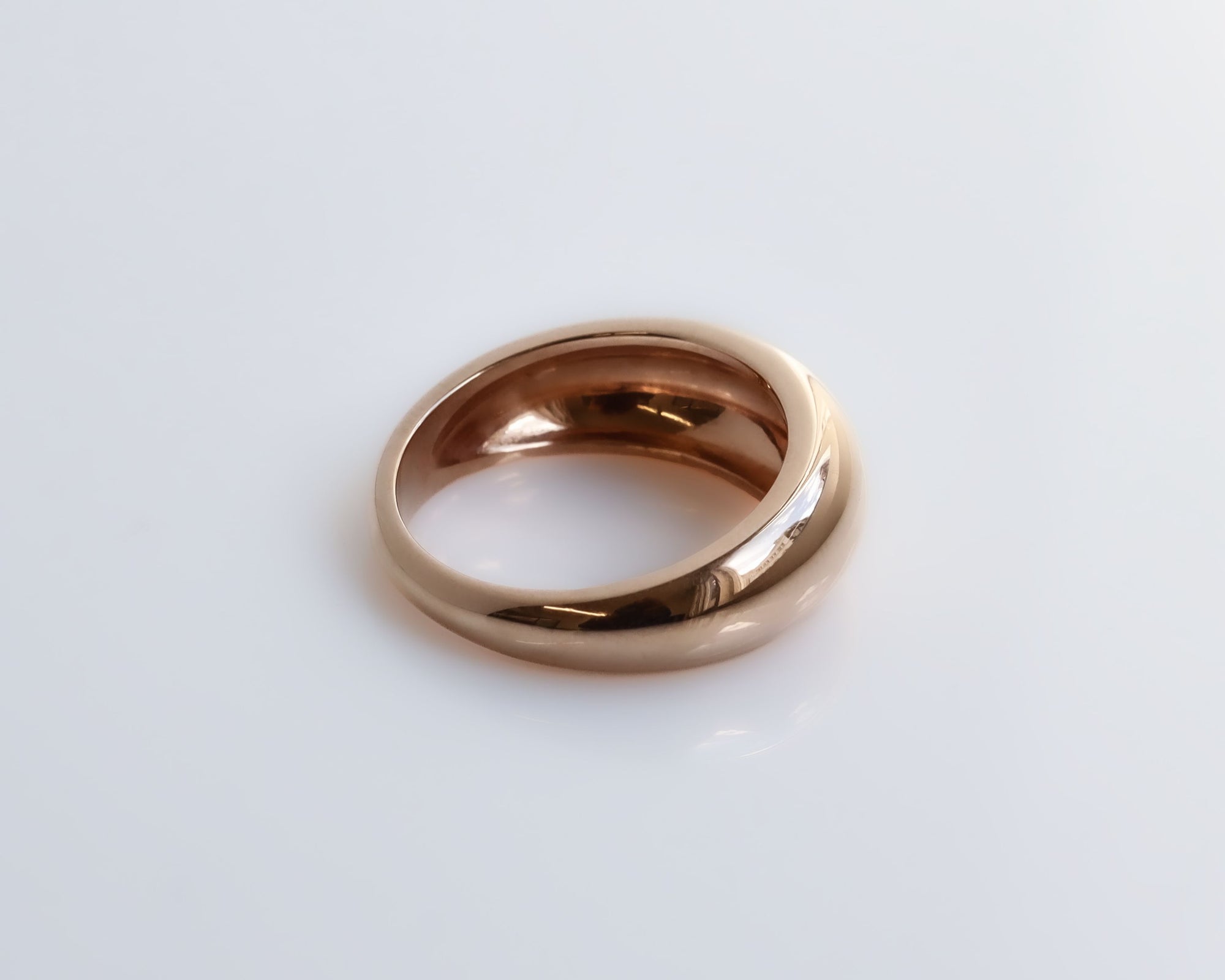 Rose gold ring on a white background