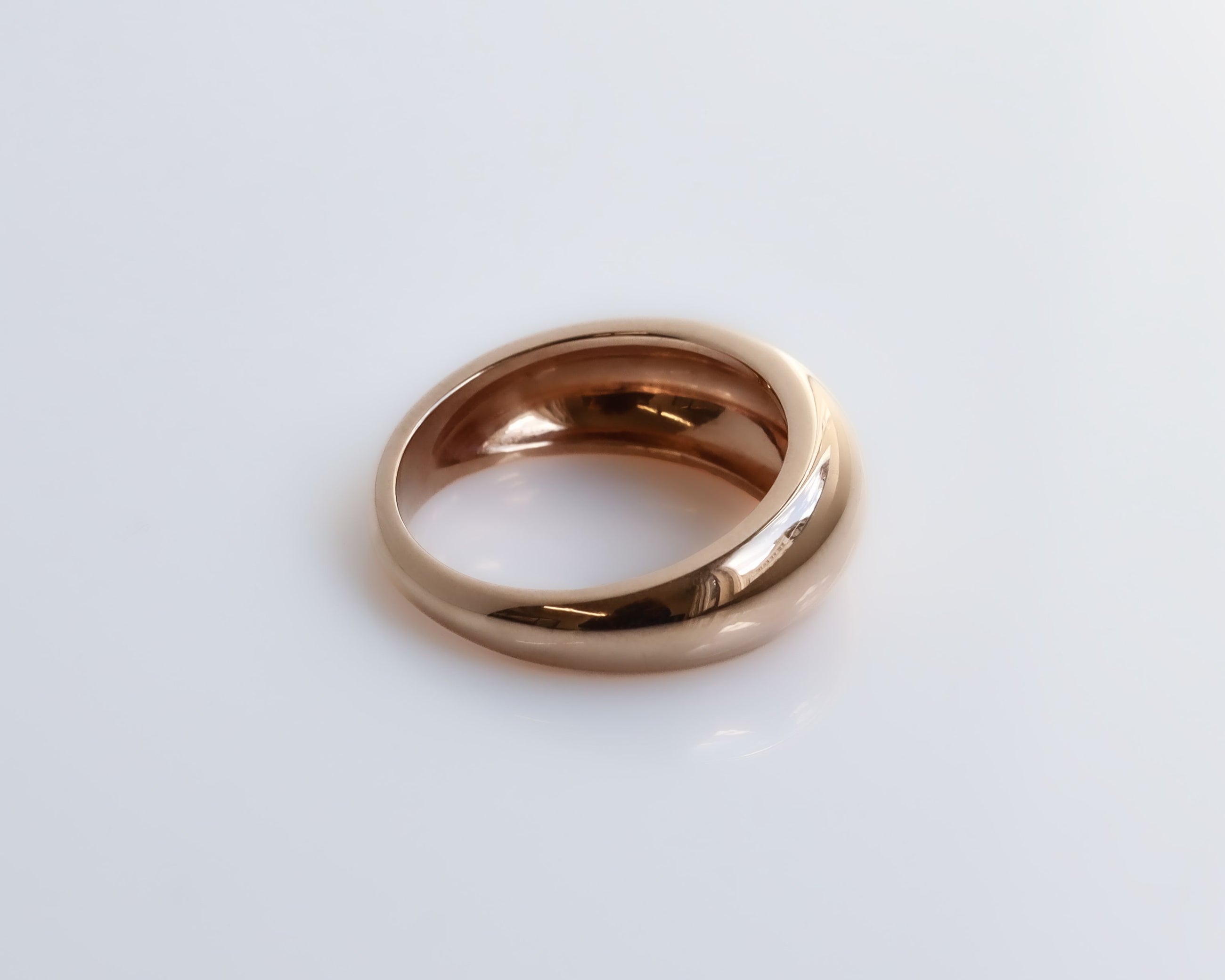 Rose gold ring on a white background