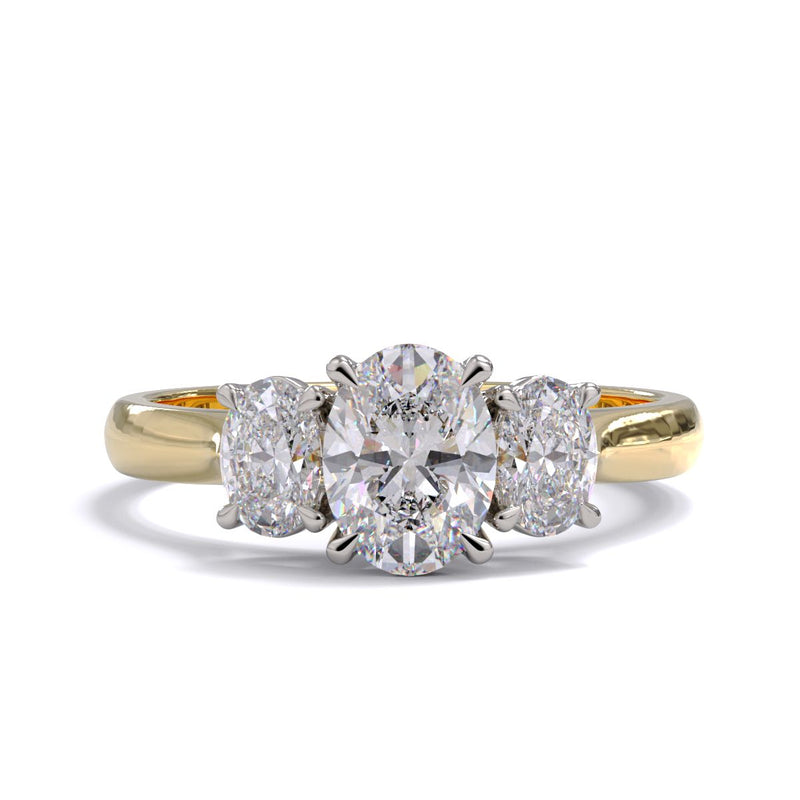 A three stone diamond engagement ring with oval diamonds set in platinum with a yellow gold band.