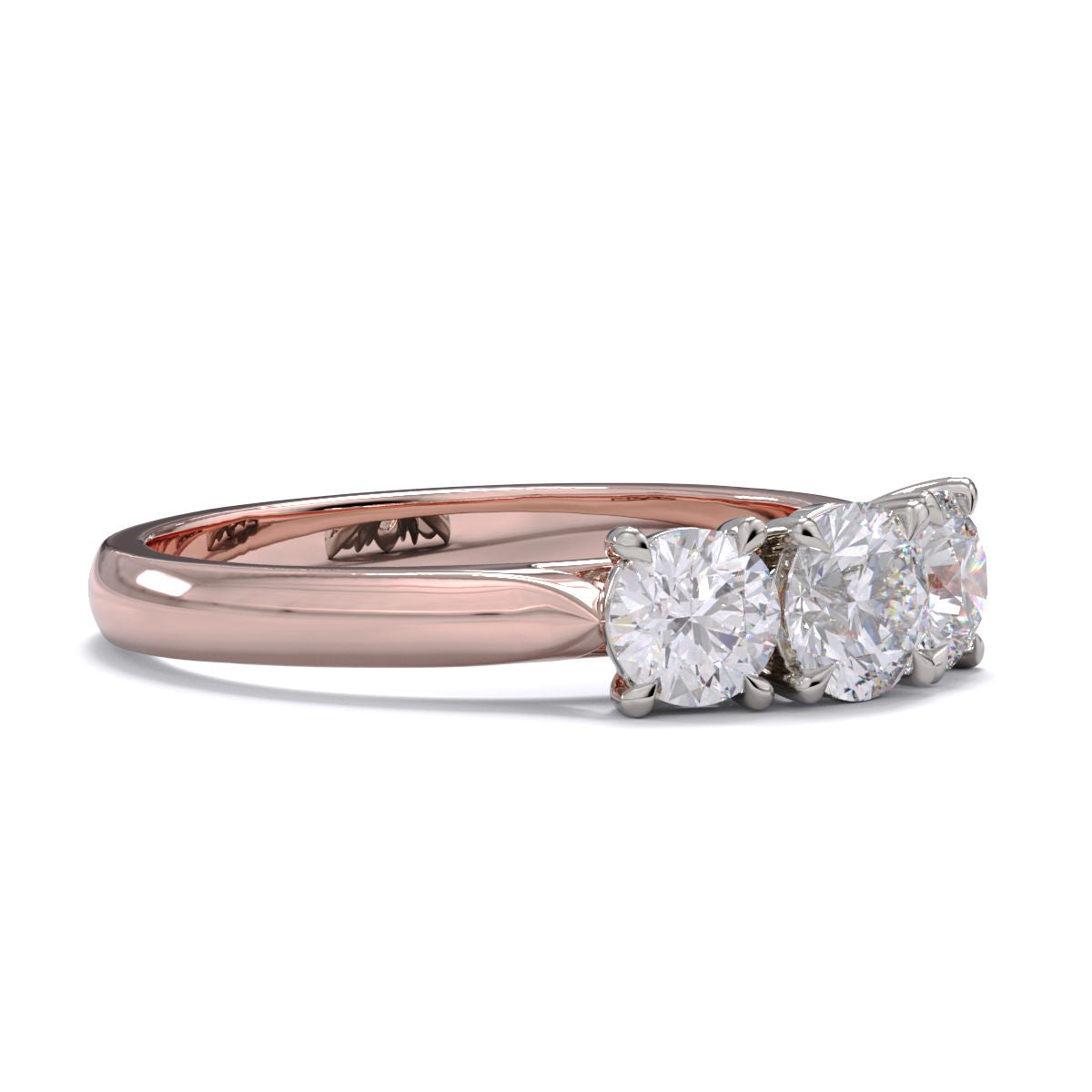 A three-stone diamond ring with a rose gold band and platinum setting for the diamonds.