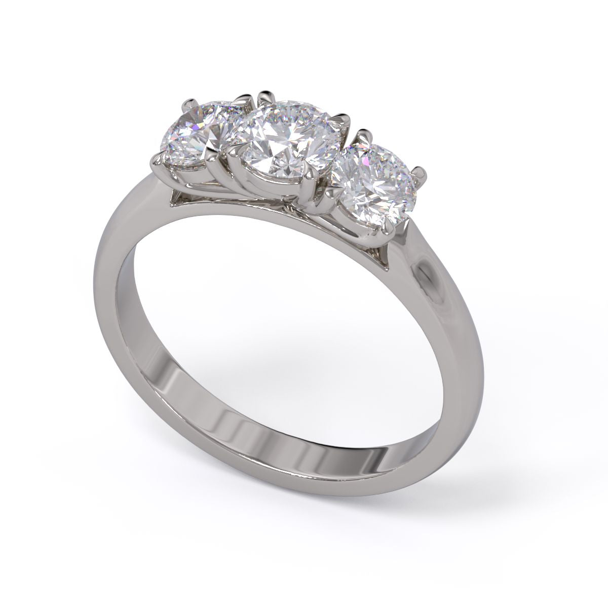 A three-stone diamond ring with a white gold or platinum band and platinum setting for the diamonds.