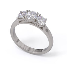 A three-stone diamond ring with a white gold or platinum band and platinum setting for the diamonds.