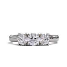 A three-stone diamond ring with a white gold or platinum band and platinum setting for the diamonds.