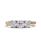 A three-stone diamond ring with a yellow gold band and platinum setting for the diamonds.