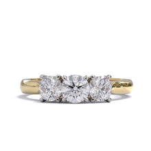 A three-stone diamond ring with a yellow gold band and platinum setting for the diamonds.