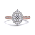 A gold diamond ring with a large round central diamond surrounded by a halo of smaller round diamonds. Set in platinum on a rose gold band with pave down on the band, displayed against a white background.