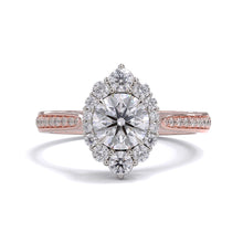 A gold diamond ring with a large round central diamond surrounded by a halo of smaller round diamonds. Set in platinum on a rose gold band with pave down on the band, displayed against a white background.