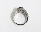 Handmade ring featuring a blue sapphire centre stone, surrounded by a halo of diamonds, with a pavé diamond band.