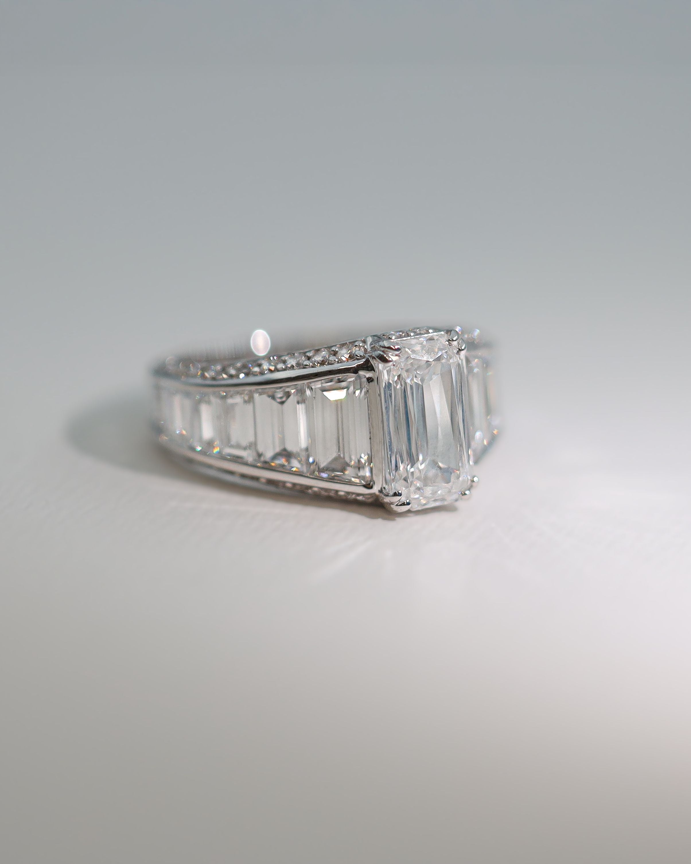 Dimond engagement ring with emerald cut center stone and Baguette Cut diamonds tapering down either side of center stone. Made in New Zealand by award winning team 