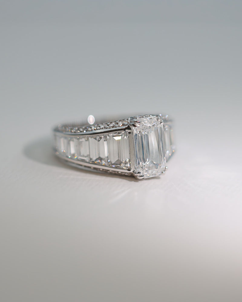 Dimond engagement ring with emerald cut center stone and Baguette Cut diamonds tapering down either side of center stone. Made in New Zealand by award winning team 