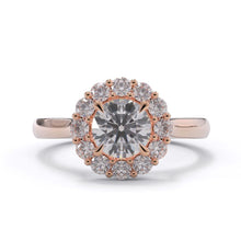 Rose gold ring with a large diamond and smaller diamonds around on a white background