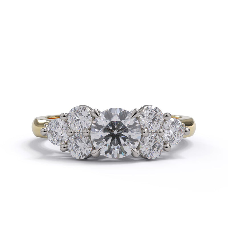 A diamond engagement featuring multiple round cut diamonds set in a platinum setting. Pave diamonds set on a yellow gold band.