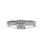 platinum solitaire ring with a diamond on a white background