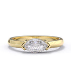 Gold ring with a large diamond on a white background