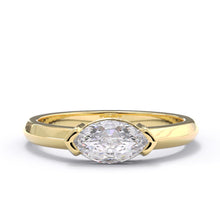 Gold ring with a large diamond on a white background