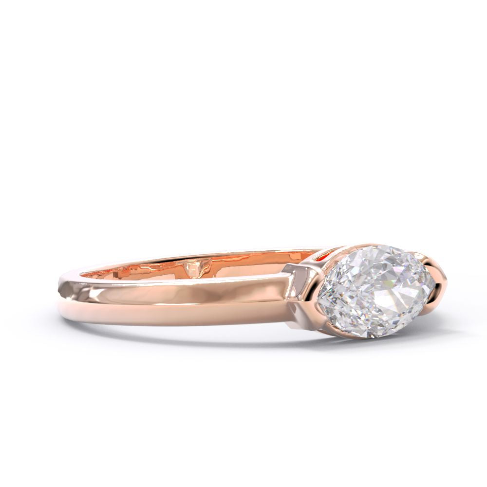 Rose gold diamond ring in a modern bezel set setting. Marquise diamond center stone.