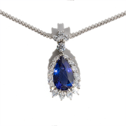 A blue tanzanite pendant necklace with a chain, encrusted with diamonds.