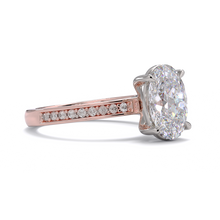 Rose gold ring with a large diamond and smaller diamonds on the band against a white background