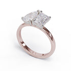 A solitaire diamond Toi et Moi style ring with a rose gold band set in a platinum setting.