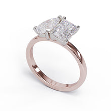 A solitaire diamond Toi et Moi style ring with a rose gold band set in a platinum setting.
