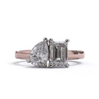 A solitaire diamond Toi et Moi style ring with a rose gold band set in a platinum setting.