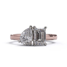 A solitaire diamond Toi et Moi style ring with a rose gold band set in a platinum setting.