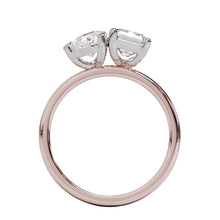 A solitaire diamond Toi et Moi style ring with a rose gold band set in a platinum setting.