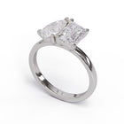 A solitaire diamond Toi et Moi style ring with a platinum or white gold band set in a platinum setting.