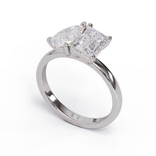 A solitaire diamond Toi et Moi style ring with a platinum or white gold band set in a platinum setting.