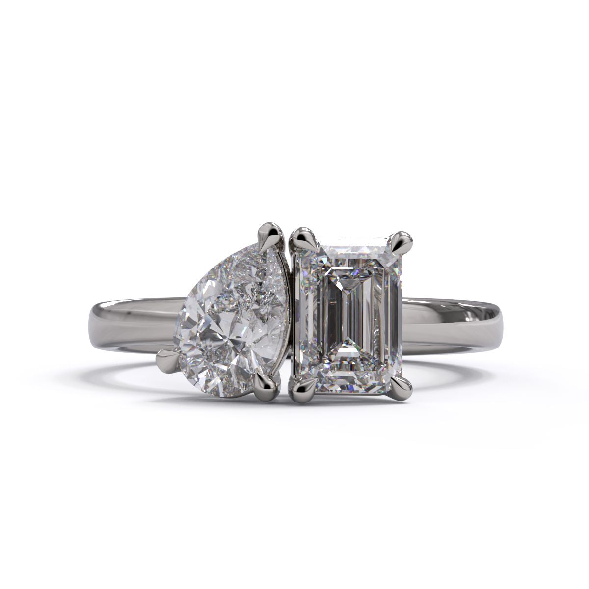 A solitaire diamond Toi et Moi style ring with a platinum or white gold band set in a platinum setting.