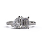 A solitaire diamond Toi et Moi style ring with a platinum or white gold band set in a platinum setting.