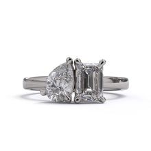 A solitaire diamond Toi et Moi style ring with a platinum or white gold band set in a platinum setting.