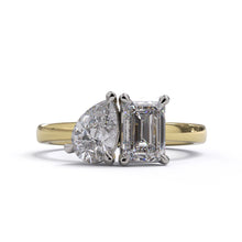 A solitaire diamond Toi et Moi style ring with a yellow gold band set in a platinum setting.