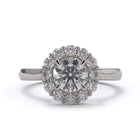 Diamond ring with a halo on a white background