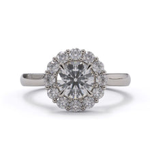 Diamond ring with a halo on a white background