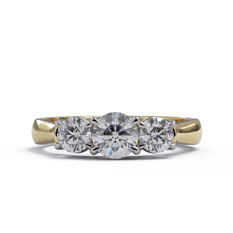 Three-stone diamond ring with yellow gold band on a white background
