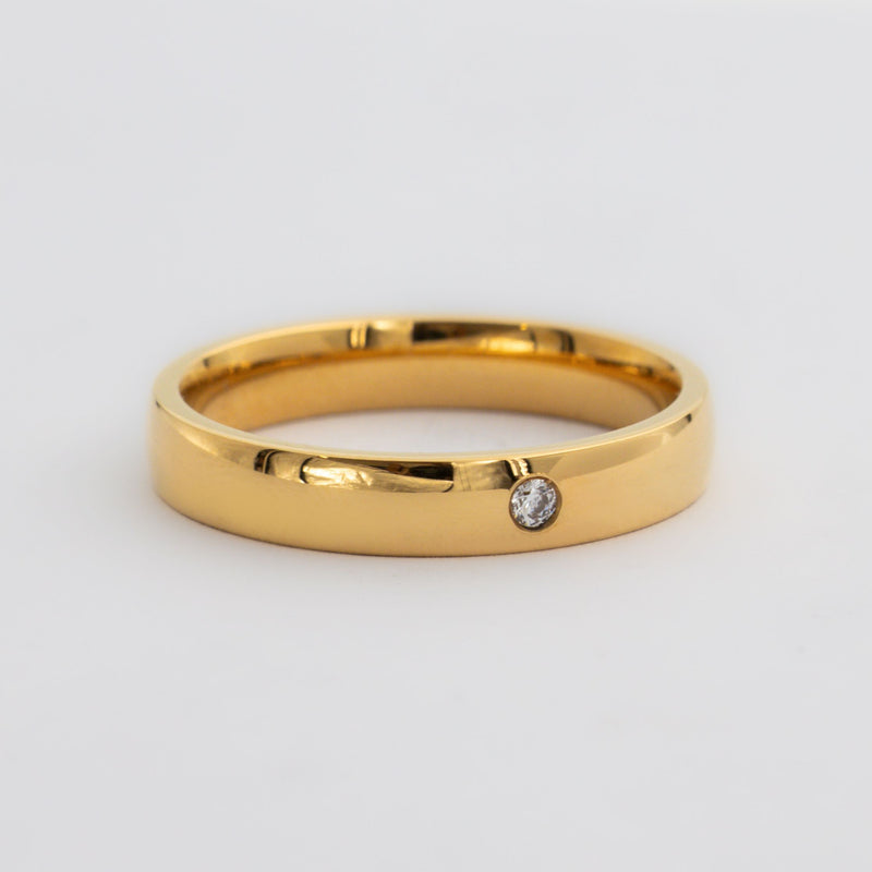 Gold wedding ring with one small round diamond 