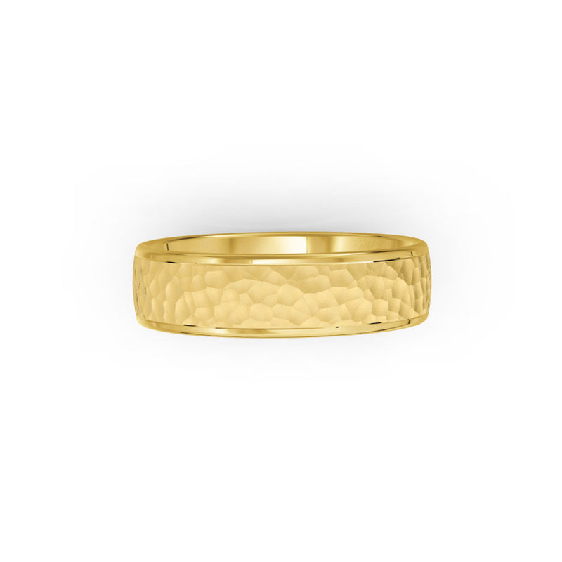 Yellow-gold men's wedding ring with a hammered finish on a white background. By Meaden Master Jewellers. Award-winning team of Jewellers, based in Auckland, New Zealand.