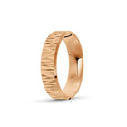 Rose gold ring with a textured band on a white background. By Meaden Master Jewellers. Award-winning team of Jewellers, based in Auckland, New Zealand.