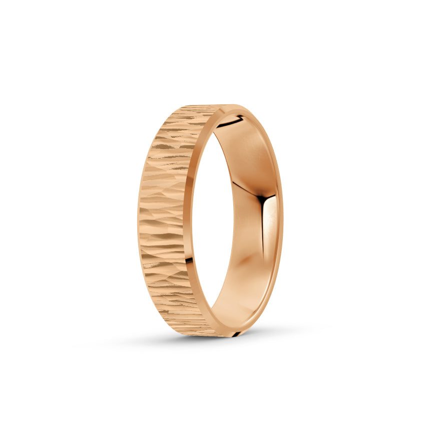 Rose gold ring with a textured band on a white background. By Meaden Master Jewellers. Award-winning team of Jewellers, based in Auckland, New Zealand.