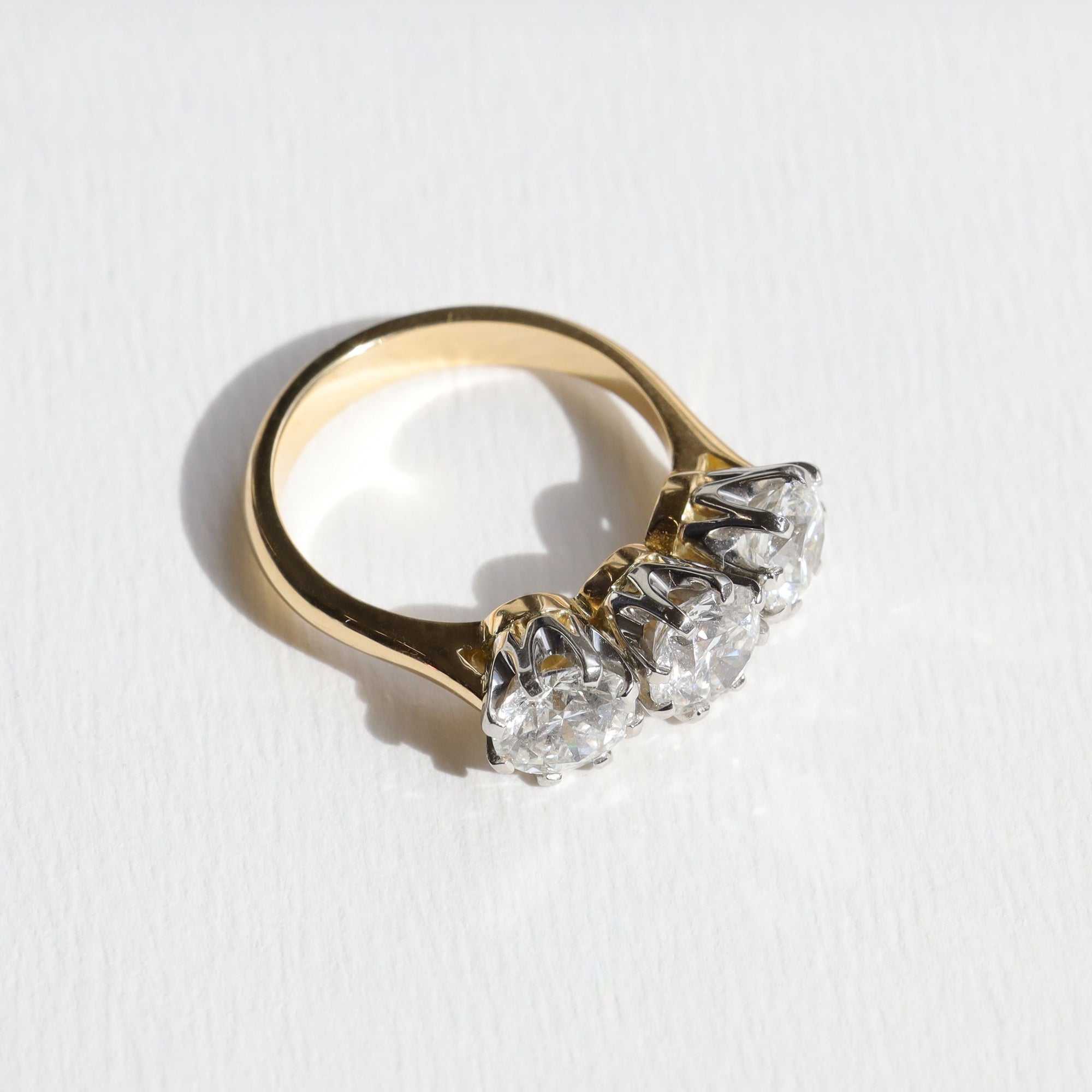 Gold emgagement ring with three diamonds on a white background. Made in Aucjkland, New Zealand.