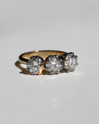 Gold diamond engagement ring with three diamonds on a light gray background. Made in Auckland, New Zealand 